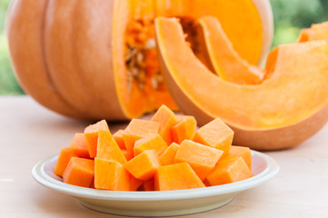 Gresh pimpkin cut in slices and pieces