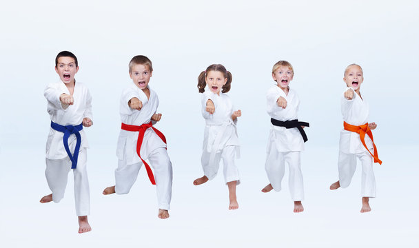 Five karateka children are beating punch arm