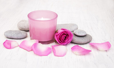 Obraz na płótnie Canvas Massage stones with pink roses