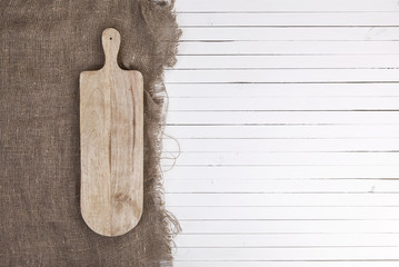 Empty cheeseboard on white wooden background, top view