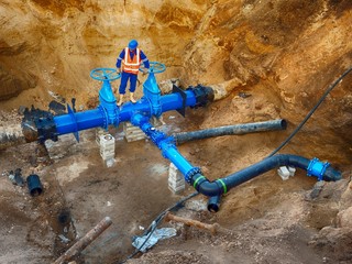 Worker underground at  gate valve on drink water system, waga multi joint members.