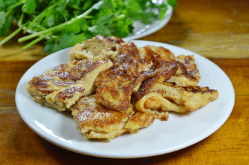 fried egg slice for piece and fresh parsley on dish