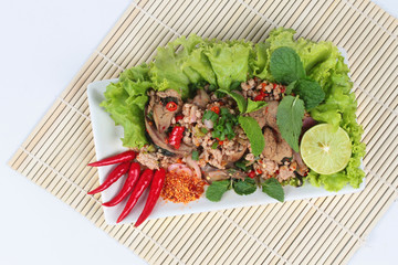 Spicy and sour mixed herb salad with pork and chicken on bamboo and white.Top view.