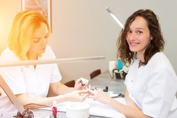 Young attractive beautician students practising during courses