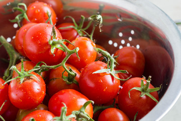 Fresh tomatoes in kitchen strainer