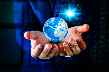 Businessman holding digital earth in hands. Technology concept.