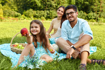 Family On Picnic. Happy Young Family Having Fun In Nature