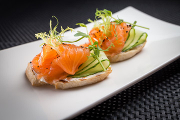 bruschetta with salmon on white palat