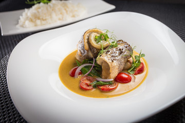 dorado with rice on white plate