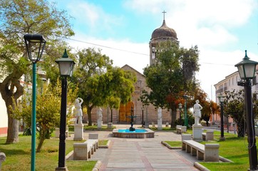Low angle view of the stone church Santo Domingo  with a blue sky with some clouds in La Serena,...