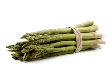 green asparagus tied together with ribbon isolated on white back