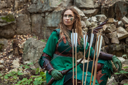 Elf woman in green leather armor with the bow