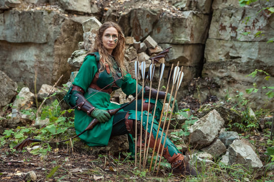 Elf woman in green leather armor with the bow