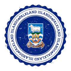 Fototapeta premium Grunge rubber stamp with Falkland Islands (Malvinas) flag. Vintage travel stamp with circular text, stars and national flag inside it. Vector illustration.