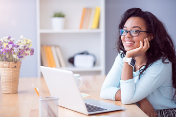 Positive woman sitting at the table