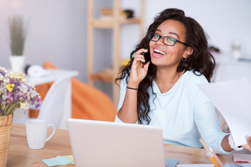 Joyful smiling woman talking on cell phone