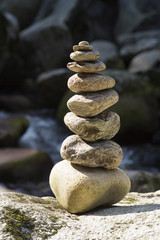 Stones pyramid on sand symbolizing zen, harmony