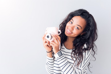 Joyful woman holding photo camera