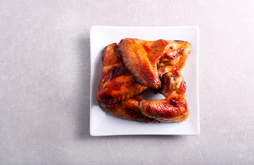 Roasted chicken wings on plate,