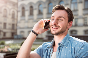 Attractive young man using phone