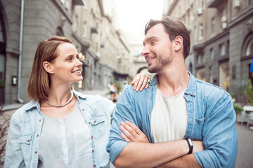 Pleasant couple standing in the street