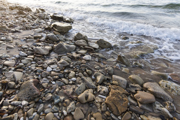 sea waves on the stone beach at sunset, Zakynthos, Greece