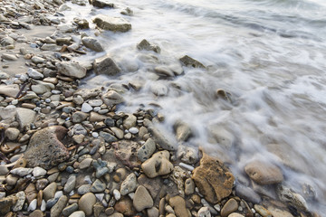 sea waves on the stone beach at sunset, Zakynthos, Greece