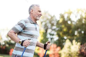 Handsome happy man in his 60s jogging