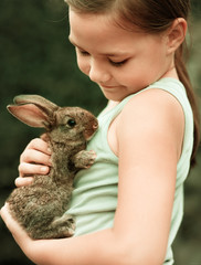 Girl is holding a little rabbit