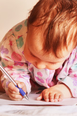 Little beautiful girl writing letter