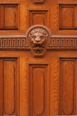 photo of wooden door with lion head