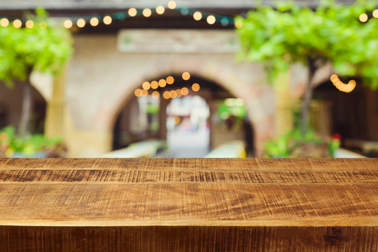 Empty Wooden Rustic Table Over Festive Market Bokeh Background