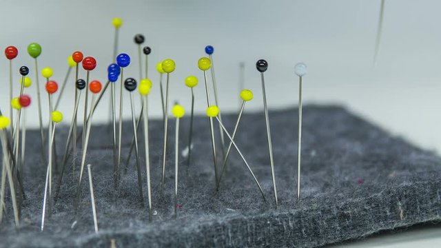Colorful pins in cushion close up
