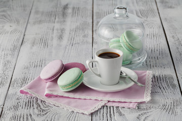 Green macaroons with coffee cup