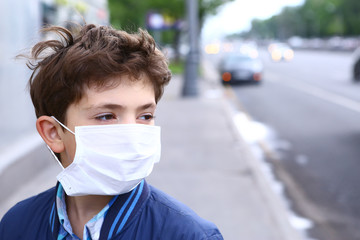 boy in protection mask on the highway city