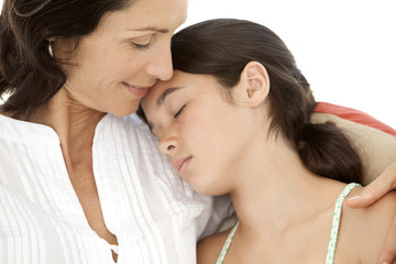 Moment of tenderness between mother and teenager daughter