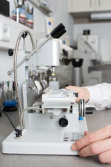 Optician preparing glases on mashine