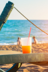 cold drink on sunbed at the beach