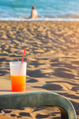 cold drink on sunbed at the beach