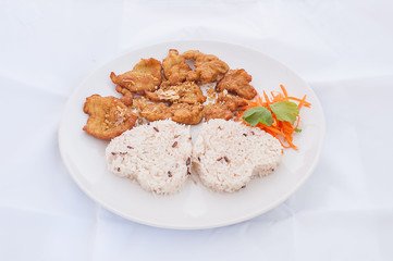 Sweet and sour chicken with rice in brown bowl