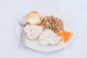 Thai stir-fried chicken and basil served with rice and fried egg