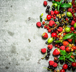 Naklejka na ściany i meble wild berries on the stone table.