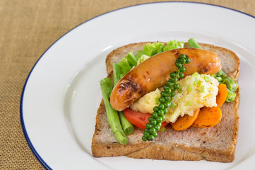 American breakfast, sausage and bread with vegetables