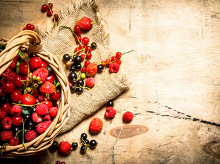 Basket with berries. On wooden table.