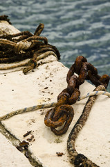 rusted chain, close up of a rusted chain used to anchor boat on a harbor pier