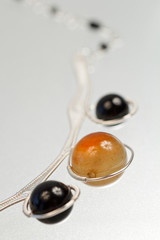 Silver jewels with colorful precious stones and light grey background
