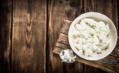 Fresh cottage cheese in a bowl .
