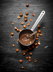 Chocolate butter with hazelnuts in a pan.