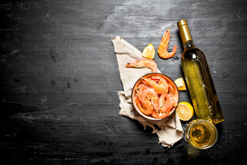 bottle of white wine with shrimp and lemon.