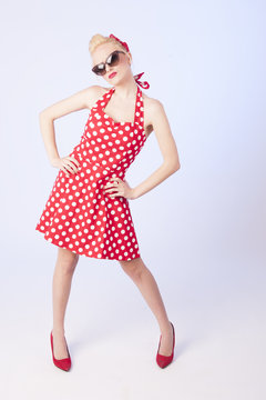 Pinup style full body portrait of a beautiful blond girl 
